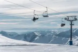 skiers and snowboarders on ski lift