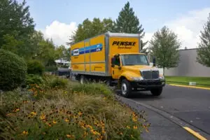 Penske truck driving down the road