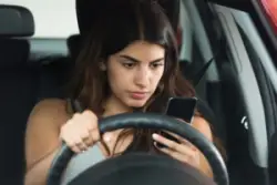 young woman on cell phone while driving