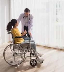 woman in wheelchair talking to her doctor