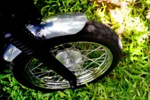 close-up on motorcycle wheel after crashing into the grass