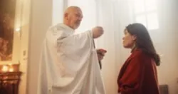priest offering a woman communion