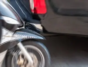 speeding motorcycle wheel crashing into car
