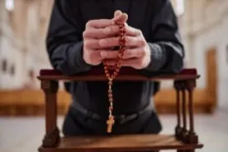 priest holding a rosary