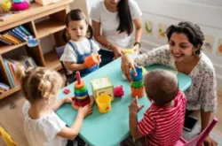 teacher playing with children in a daycare