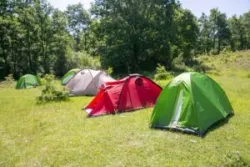 campers in tents on a hill