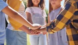 children putting their hands together