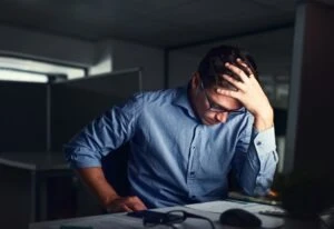 distressed man sitting in the dark