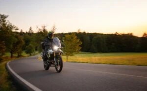 man riding a motorcycle at sunset