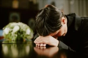 woman crying on coffin