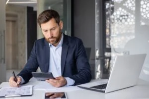 A lawyer at his desk calculating how much it costs to hire a clergy abuse lawyer