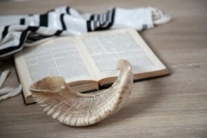 A yamaka on top of a copy of the Torah. What are your rights in Rabbi sexual abuse claims?