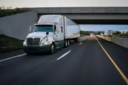Semi truck,commercial,vehicle,18,wheeler,on,highway,with,overpass
