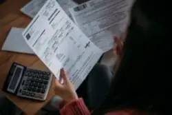 Close up,of,female,hands,with,pay,slips,,utility,bills,,account