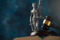 Judge’s,gavel,on,themis,statue,background