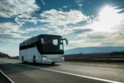 White bus on two lane highway