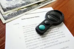 Key, money and auto insurance policy paper