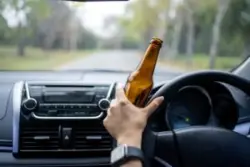 Driving with beer bottle