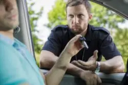 Driver hands keys to grumpy officer