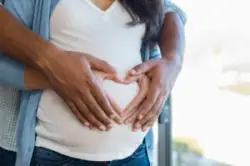 Man and woman hands on pregnant belly